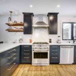 Modern kitchen with black cabinets and marble countertops