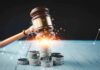 Gavel, coins, and tax icons on a table
