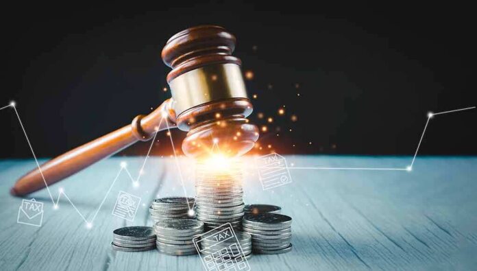 Gavel, coins, and tax icons on a table