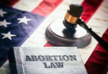 Book titled Abortion Law gavel American flag background