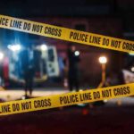 Yellow police tape in front of crime scene.