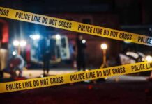 Yellow police tape in front of crime scene