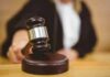 Judge using a gavel in courtroom