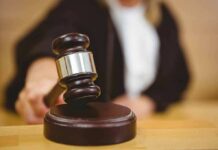 Judge using a gavel in courtroom