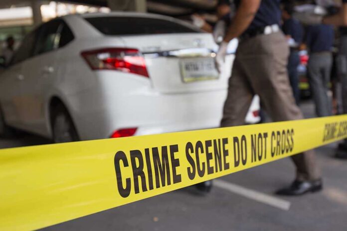 351048443 featured image Crime scene tape blocking off white sedan