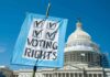 Sign reading Voting Rights in front of Capitol building