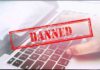 Red Banned stamp over a laptop keyboard