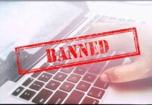 Red Banned stamp over a laptop keyboard