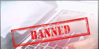 Red Banned stamp over a laptop keyboard