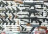 Wall display of various firearms in a store