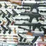 Wall display of various firearms in a store