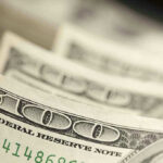 Trump vs. Fed: Explosive Clash Over Rates Close up of hundred-dollar bills