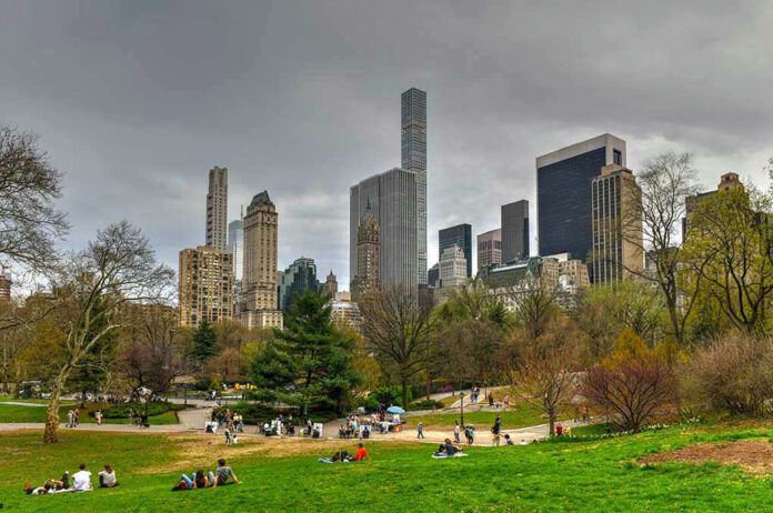 1382597744 City skyline with park and people relaxing