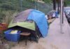 Tents and belongings set up along sidewalk