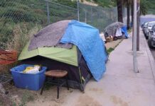 Tents and belongings set up along sidewalk