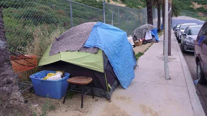 1392494762 featured image Tents and belongings set up along sidewalk