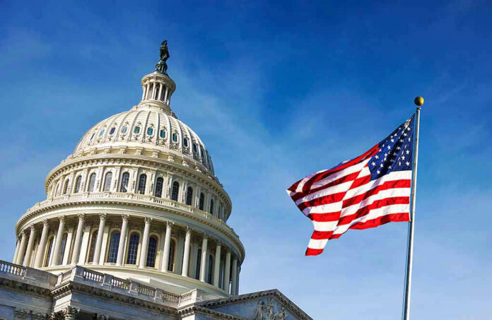 1418358686 US Capitol building with American flag in foreground