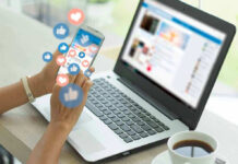 Person using smartphone and laptop with social media icons
