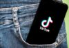 Phone with TikTok logo in jeans pocket