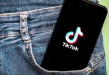 Phone with TikTok logo in jeans pocket