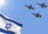 Israeli flag with three fighter jets flying overhead