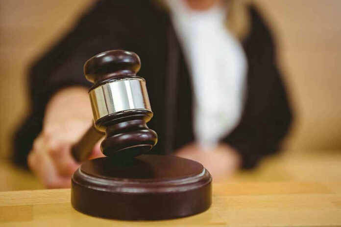 243995698 Judge striking gavel in a courtroom