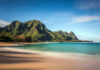 Beach with mountains and clear blue water
