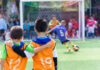 Two boys watching a soccer game together