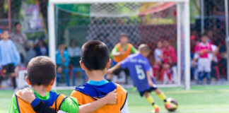 Two boys watching a soccer game together