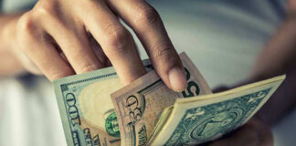 Person holding multiple bills