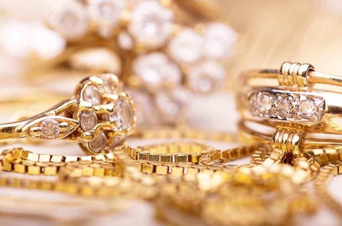 shutterstock_225498538.jpg Close up of various gold rings adorned with sparkling gems