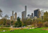 City skyline with park and people relaxing.
