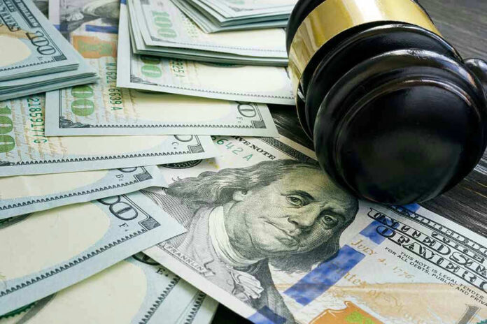 2006624330 Gavel and hundred dollar bills on table.