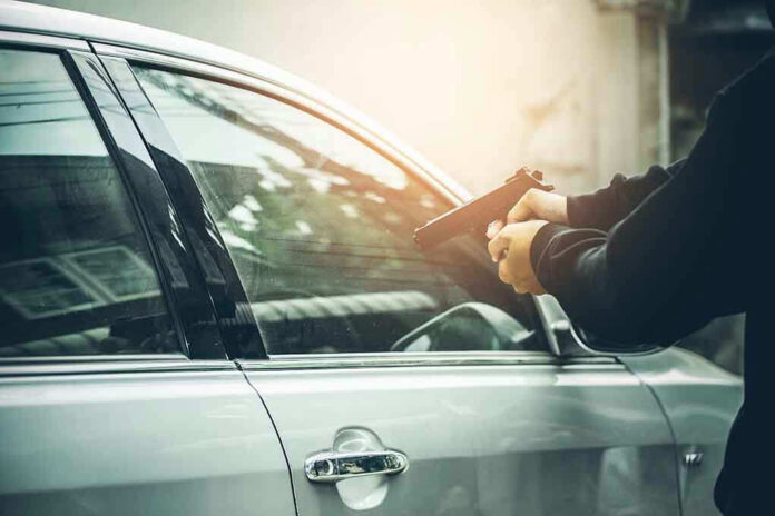 604771622 Person pointing gun at car window