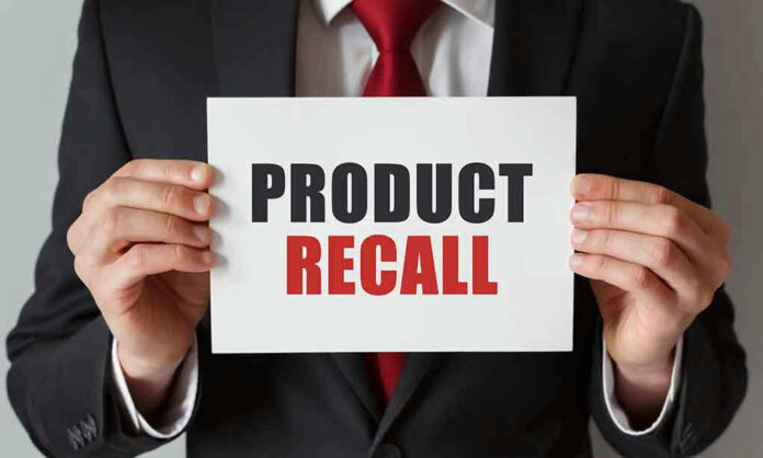 741529771 "Product Recall" sign held by person in suit.