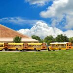 Killer Driver’s Shockingly Lenient Sentence A row of yellow school buses parked in front of a school building under a cloudy sky