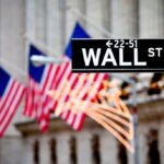 Wall Street’s Secret Utility Agenda—Hidden Costs Revealed Wall Street sign with American flags in the background