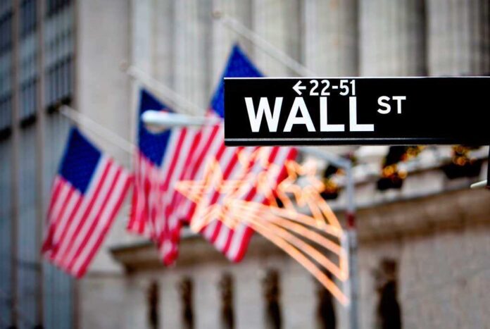 shutterstock_93231562.jpg Wall Street sign with American flags in the background
