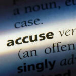 Close-up dictionary definition of accuse underlined.