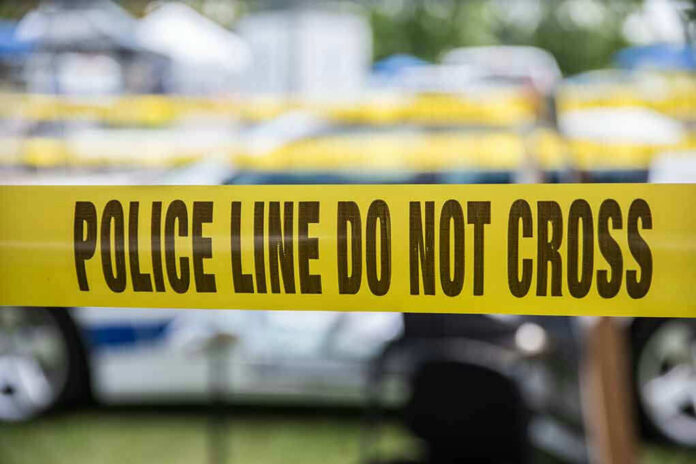627591236 Yellow police line tape with Do Not Cross.