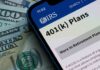 Mobile phone displaying IRS information about 401(k) plans on a background of cash