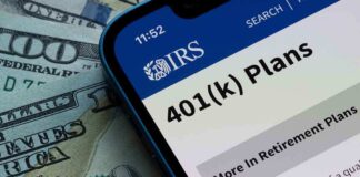 Mobile phone displaying IRS information about 401(k) plans on a background of cash