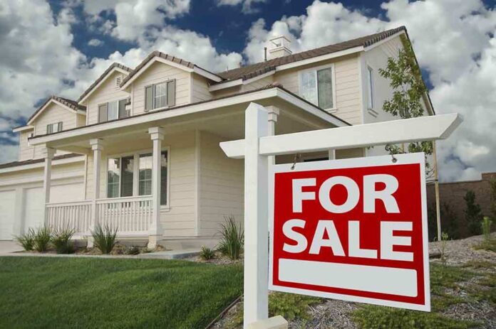 shutterstock_21431701.jpg A suburban house with a For Sale sign in the front yard