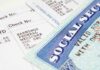 Close-up of a pay stub and a social security card