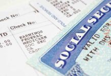 Close-up of a pay stub and a social security card