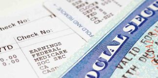 Close-up of a pay stub and a social security card