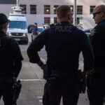 Gun Rights Flashpoint — Compton’s Deadly Encounter Three police officers standing on a city street.