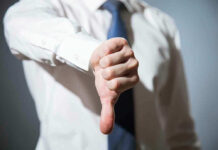 Person giving a thumbs down gesture.