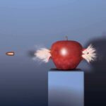 A red apple being struck by a bullet, showing an explosion effect
