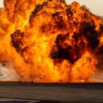 A large explosion creating a massive fireball and smoke